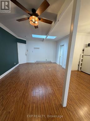Toronto (Junction Area) multi-family for rent - A room with wooden flooring and a ceiling fan.