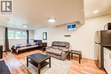 Guelph apartment for rent - A living room with a grey couch and a wooden coffee table.