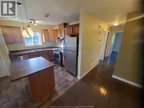 Windsor apartment for rent - A kitchen with wooden cabinets and a refrigerator.