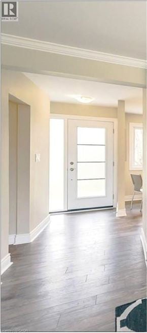St. Catharines apartment for rent - A room with a wooden floor and a white door.
