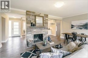 St. Catharines apartment for rent - A living room with a stone fireplace and a large mirror above it.