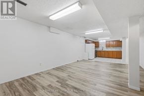 Pickering (Amberlea) apartment for rent - A spacious room with wooden flooring and white walls.