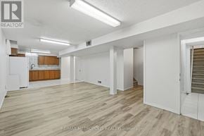 Pickering (Amberlea) apartment for rent - A spacious room with wooden flooring and white walls.