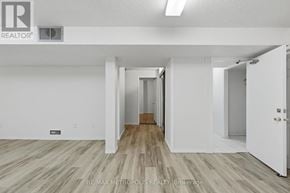 Pickering (Amberlea) apartment for rent - A white room with a wooden floor and a door on the right side.