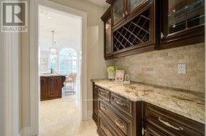 Richmond Hill (Oak Ridges Lake Wilcox) apartment for rent - A kitchen with granite countertops and wooden cabinets.