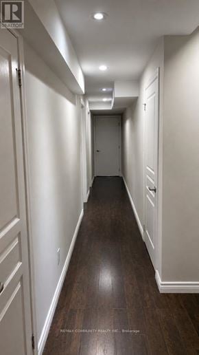 Markham (Berczy) apartment for rent - A long hallway with white walls and wood floors.