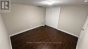 Markham (Berczy) apartment for rent - A room with a wooden floor and white walls, with a sign that reads "RE/MAX COMMUNITY REALTY INC., Brokerage".