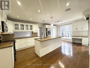 Toronto (Banbury-Don Mills) apartment for rent - A kitchen with white cabinets and a wooden floor.