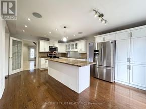 Toronto (Banbury-Don Mills) apartment for rent - A kitchen with white cabinets and a wooden floor.