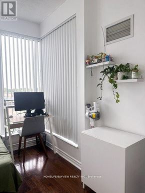 Toronto (Willowdale East) condo for rent - A room with a desk, chair, and a window with blinds.