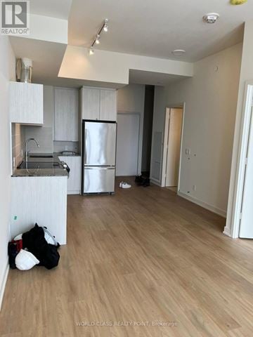 Toronto (Parkwoods-Donalda) condo for rent - A kitchen with white cabinets and a black bag on the floor.