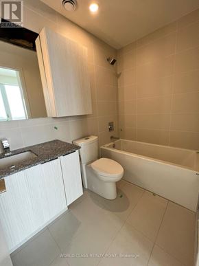 Toronto (Parkwoods-Donalda) condo for rent - A white toilet sits in a bathroom next to a bathtub.