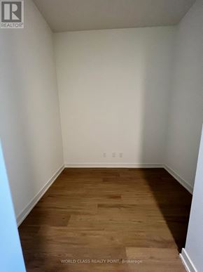 Toronto (Parkwoods-Donalda) condo for rent - A room with wooden flooring and white walls.