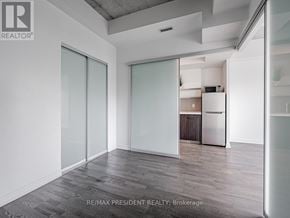 Toronto (Waterfront Communities) condo for rent - A room with a sliding glass door and a wooden floor.