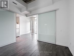 Toronto (Waterfront Communities) condo for rent - A room with a glass door and a wooden floor.