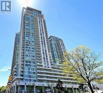 Toronto (Bendale) condo for rent - A tall residential building with many windows and balconies is shown on a sunny day.