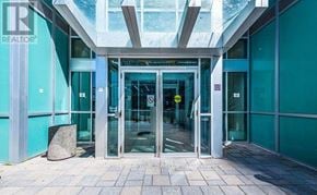 Toronto (Bendale) condo for rent - The entrance to a building with a glass door and a stone pedestal in front.