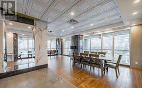 Toronto (Bendale) condo for rent - A dining room with a marble table and chairs.
