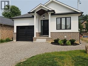 Hamilton apartment for rent - A white house with a black door and windows.