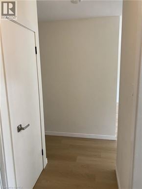 Kitchener apartment for rent - A white door is in a room with a wooden floor.