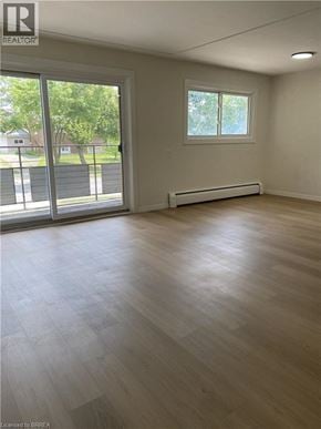 Kitchener apartment for rent - A room with a window and sliding glass doors.