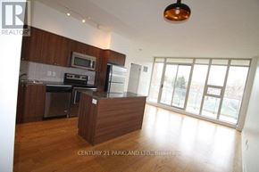 Toronto (High Park North) condo for rent - A kitchen with wooden cabinets and a refrigerator.