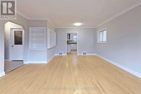 Toronto (Willowdale West) apartment for rent - A spacious room with wooden flooring and white walls.