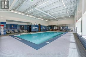 Toronto (St. Andrew-Windfields) townhouse for rent - A large indoor swimming pool with a blue tiled floor.