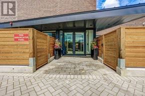 Toronto (St. Andrew-Windfields) townhouse for rent - The entrance to a building with a fire annunciator panel on the wall.
