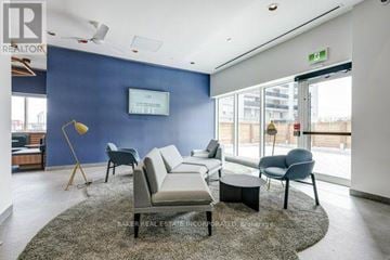 Toronto (St. Andrew-Windfields) townhouse for rent - A living room with a grey rug and a white sofa.