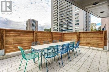 Toronto (St. Andrew-Windfields) townhouse for rent - A patio with a table and chairs is set up on a balcony.