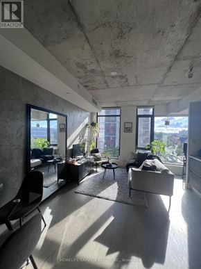 Toronto (Waterfront Communities) condo for rent - A living room with a couch, chairs, and a large window.