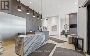 Milton (Co Coates) condo for rent - A reception area with a marble counter and a sign that says "REALTOR".