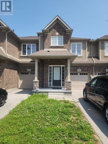 Welland (West Welland) townhouse for rent - A house with a black car parked in front.