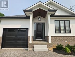 Hamilton (Gourley) apartment for rent - A house with a black front door and a small porch.