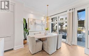 Mississauga (Mineola) townhouse for rent - A dining room with a table and chairs and a plant.