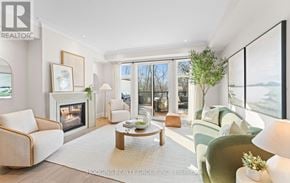 Mississauga (Mineola) townhouse for rent - A modern living room with a fireplace and a view of the lake.