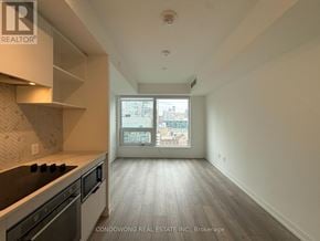Toronto (Church-Yonge Corridor) condo for rent - A room with a black chair and a black ottoman.