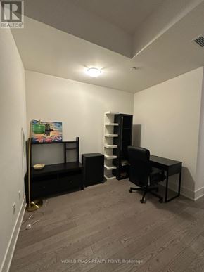 Toronto (Waterfront Communities) condo for rent - A room with a desk, chair, and shelves.