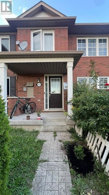 Toronto (Rouge) townhouse for rent - A red brick house with a bicycle parked in front.