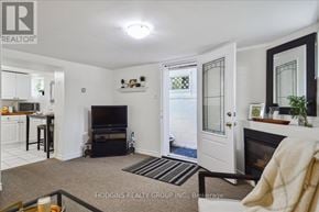 Mississauga (Mineola) multi-family for rent - A living room with a fireplace and a television.