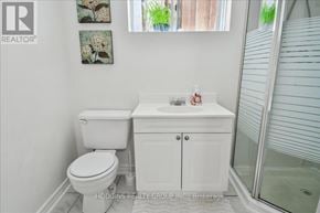 Mississauga (Mineola) multi-family for rent - A white toilet and sink in a bathroom.