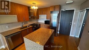 Toronto (Islington-City Centre West) condo for rent - A kitchen with wooden cabinets and granite countertops.