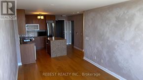 Toronto (Islington-City Centre West) condo for rent - A kitchen area with wooden floors and a countertop.