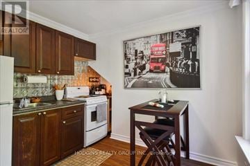 Mississauga (Mineola) multi-family for rent - A kitchen with wooden cabinets and a fridge, a stove and a table with a chair.