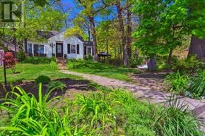 Mississauga (Mineola) multi-family for rent - A white house with a green lawn in front.