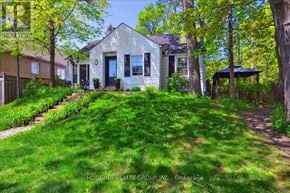Mississauga (Mineola) multi-family for rent - A house with a green lawn in front of it.