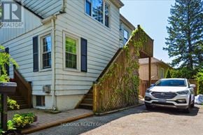 Mississauga (Mineola) multi-family for rent - A white house with a car parked in front.