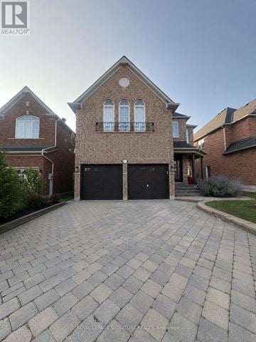Mississauga (Meadowvale Village) apartment for rent - A brick house with a driveway in front.