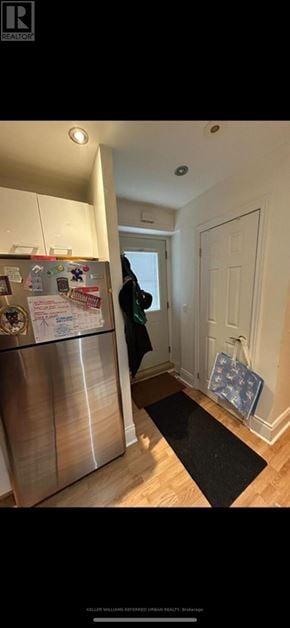 Toronto (University) triplex for rent - A kitchen with a refrigerator and a person standing in the doorway.